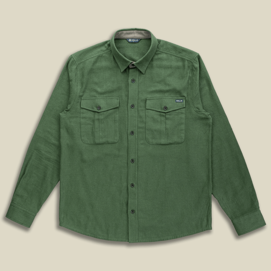 Green shirt with two front pockets on a beige background